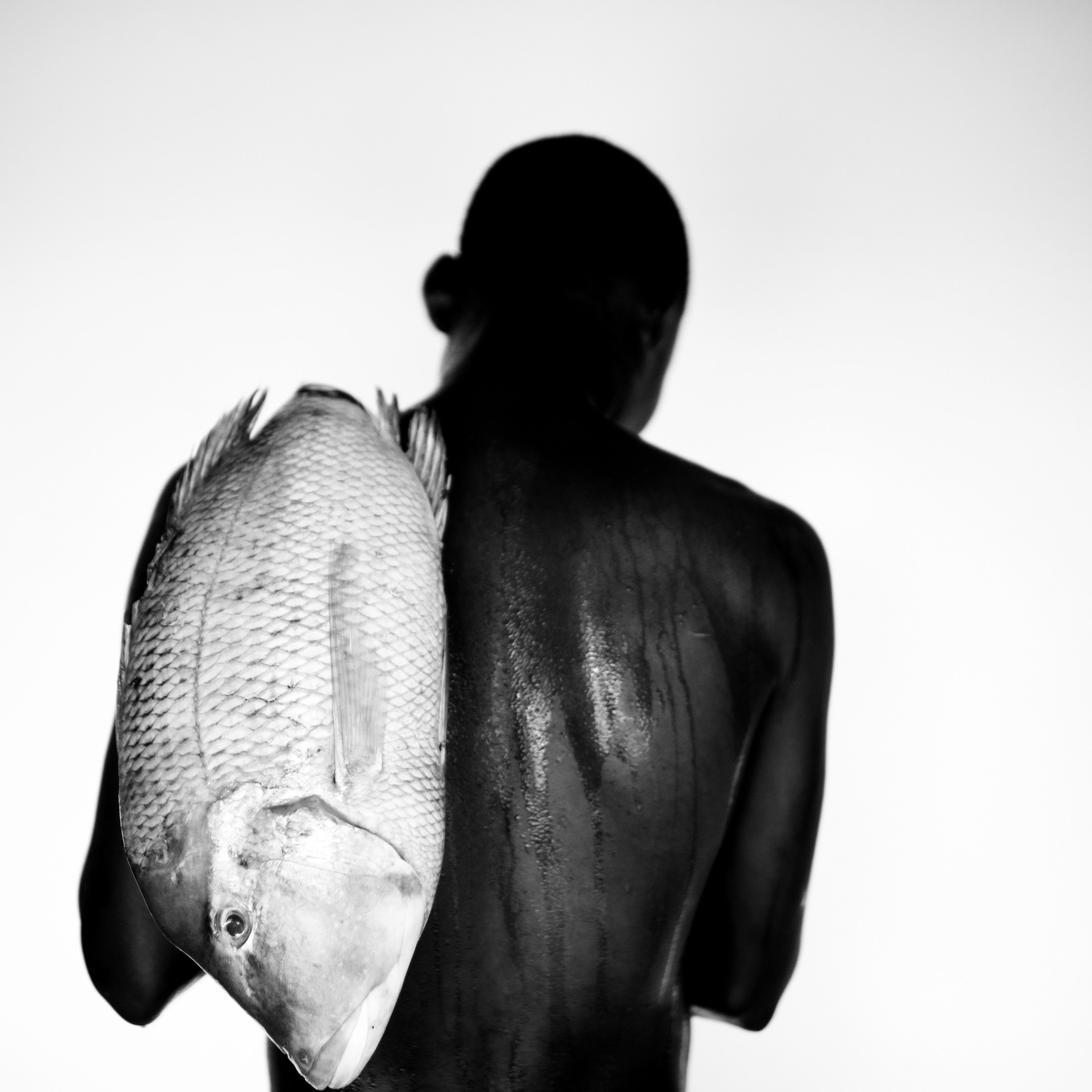 Mario Macilau, Boy with a Fish II, from the Faith series, 2022